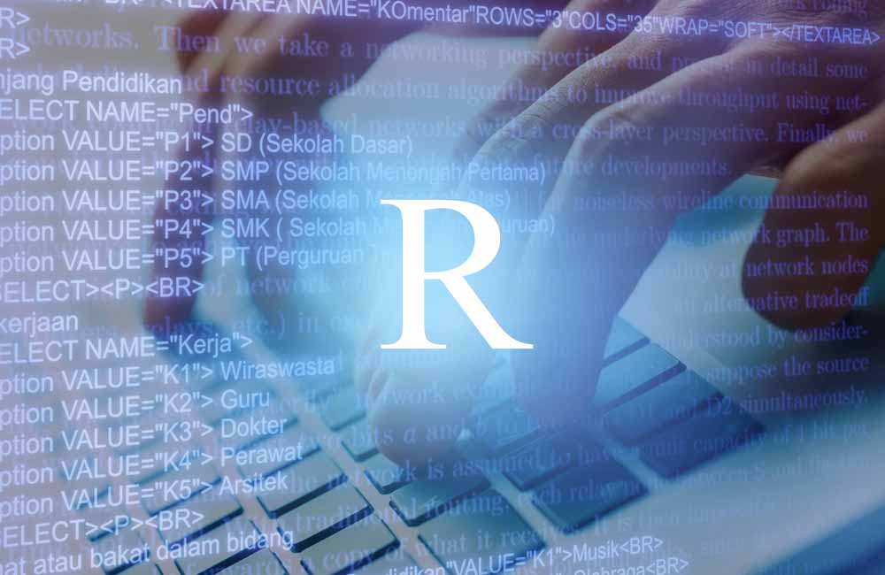 PCキーボードを操作する人の手元とRの文字
